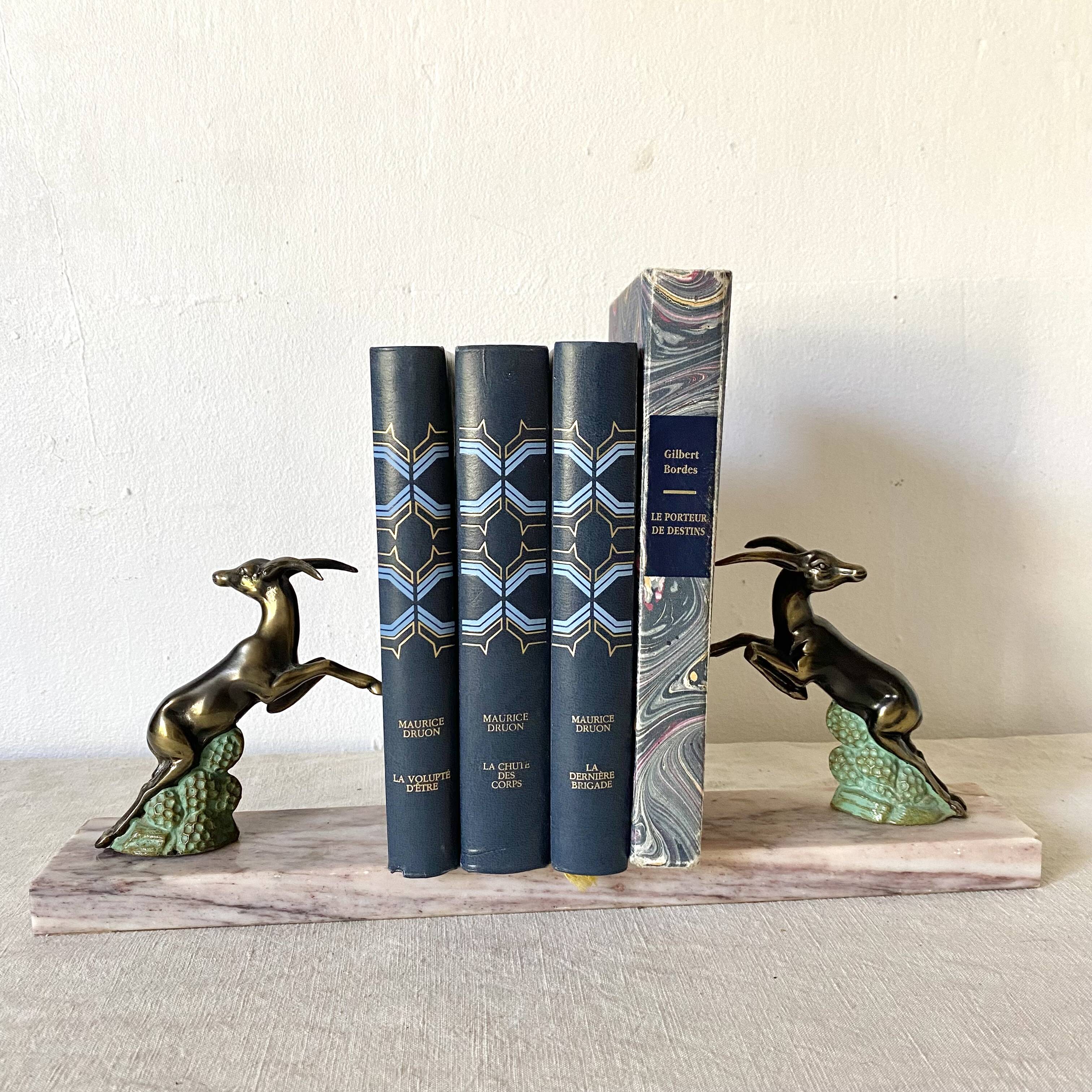 Art deco bookends in pink marble and spelters, antelopes