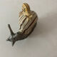 Porcelain figurine snail and its small