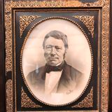 Black and gilded ebonite frame, wood and plaster 19th century
