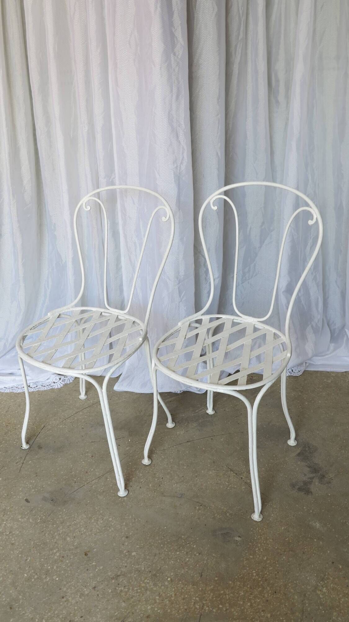 Pair of antique garden chairs, wrought iron, white paint.