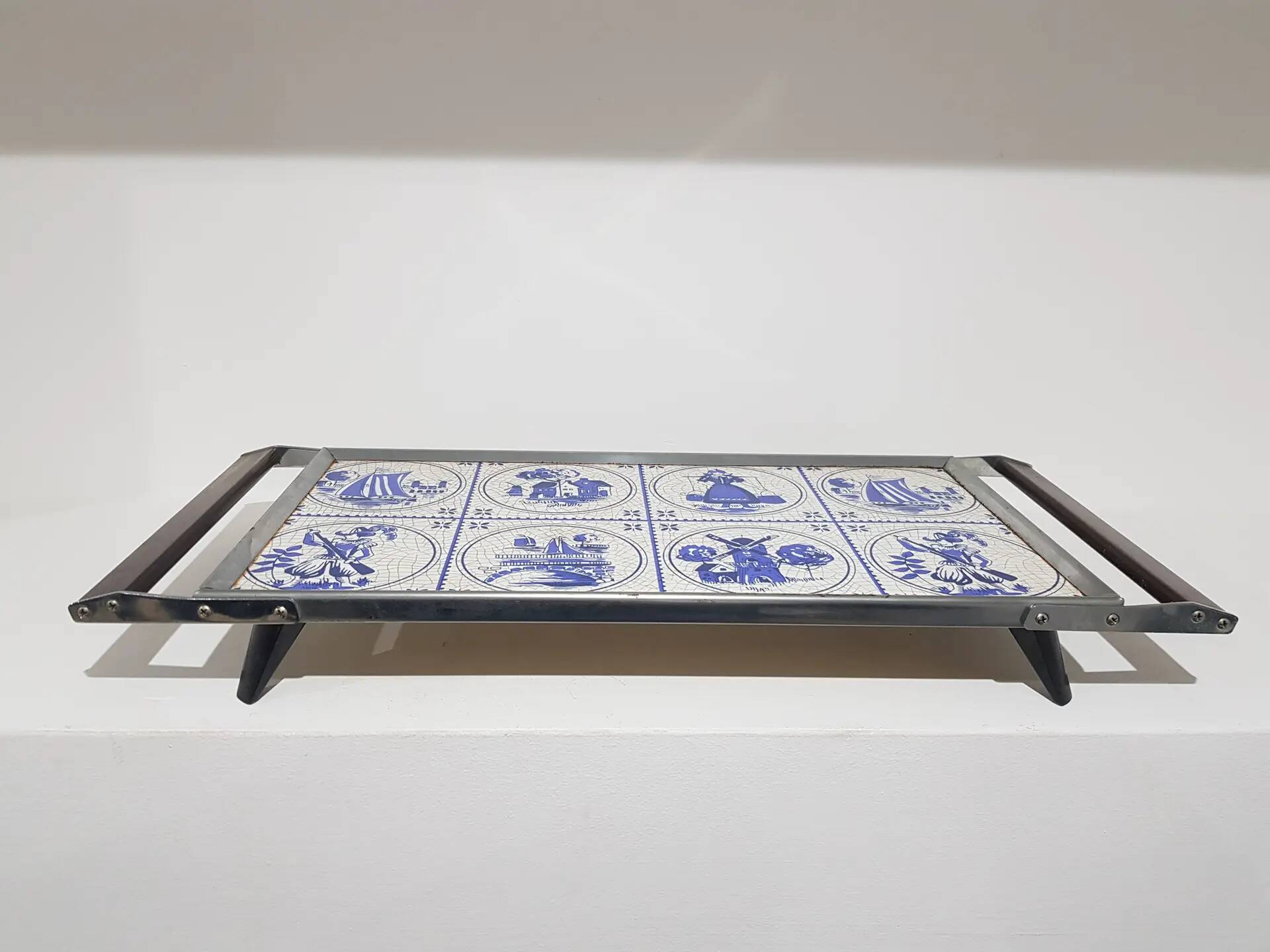 Heating plate, blue and white ceramic, brown rosewood, black metal, Germany, 1970s.
