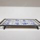 Heating plate, blue and white ceramic, brown rosewood, black metal, Germany, 1970s.