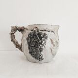 Pitcher bunches of grapes in relief