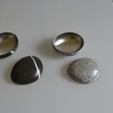 2 boxes in lithographed sheet metal in the shape of a pebble
