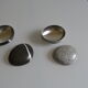 2 boxes in lithographed sheet metal in the shape of a pebble