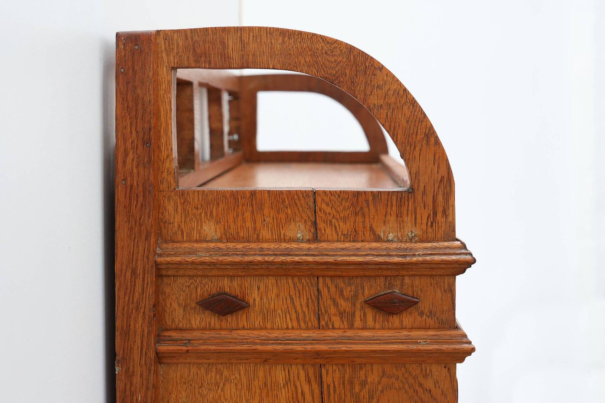 Art Deco oak wall cabinet with amber glazed door, Belgium ca. 1925