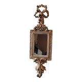 Louis XVI/Baroque style rectangular mirror. In polyresin with golden patina/Cérusée. Fronton knot. Dim. 47 x 14 cm