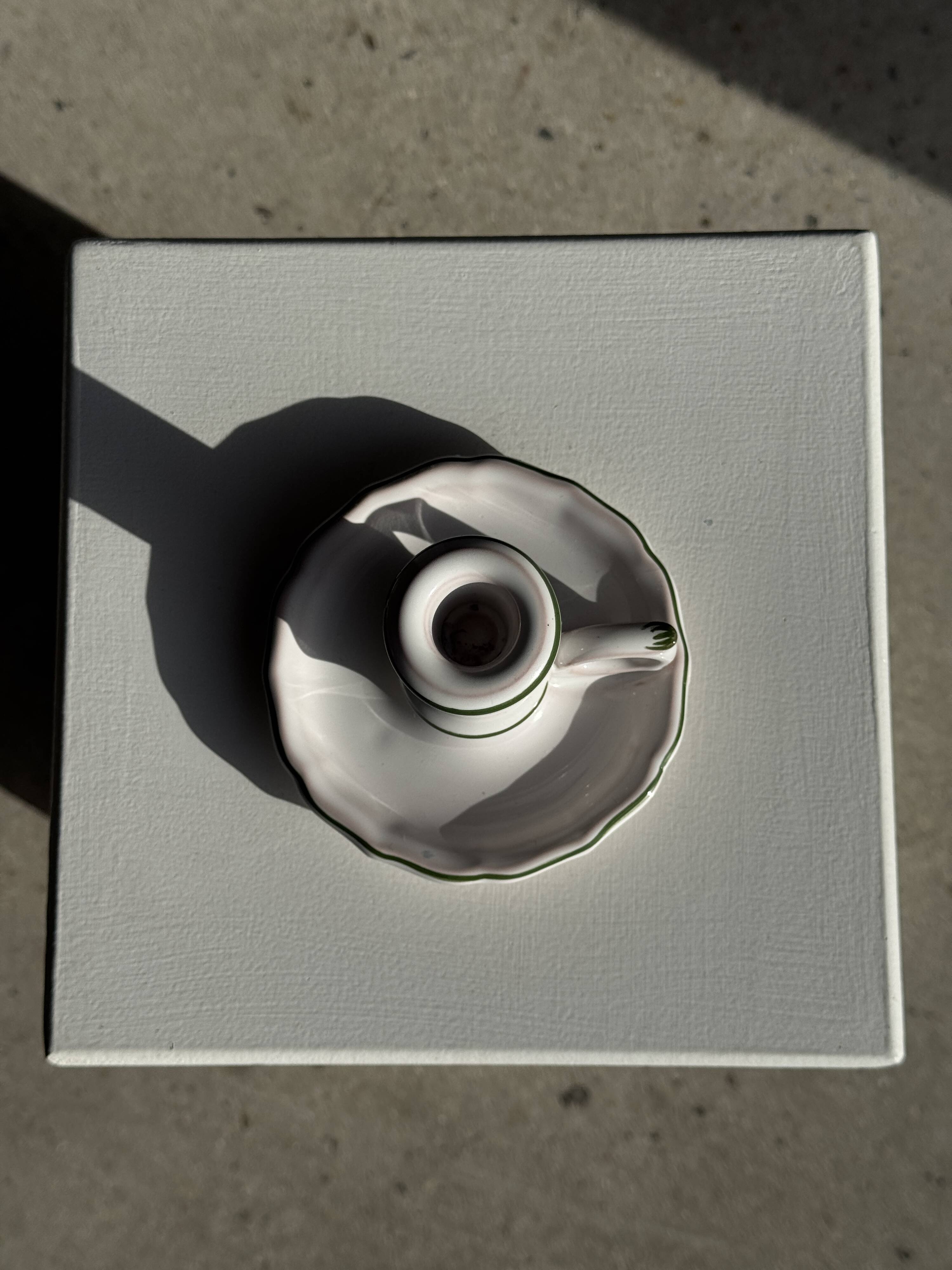 Small vintage hand-held candlestick in earthenware with green trim and floral decoration H10.5