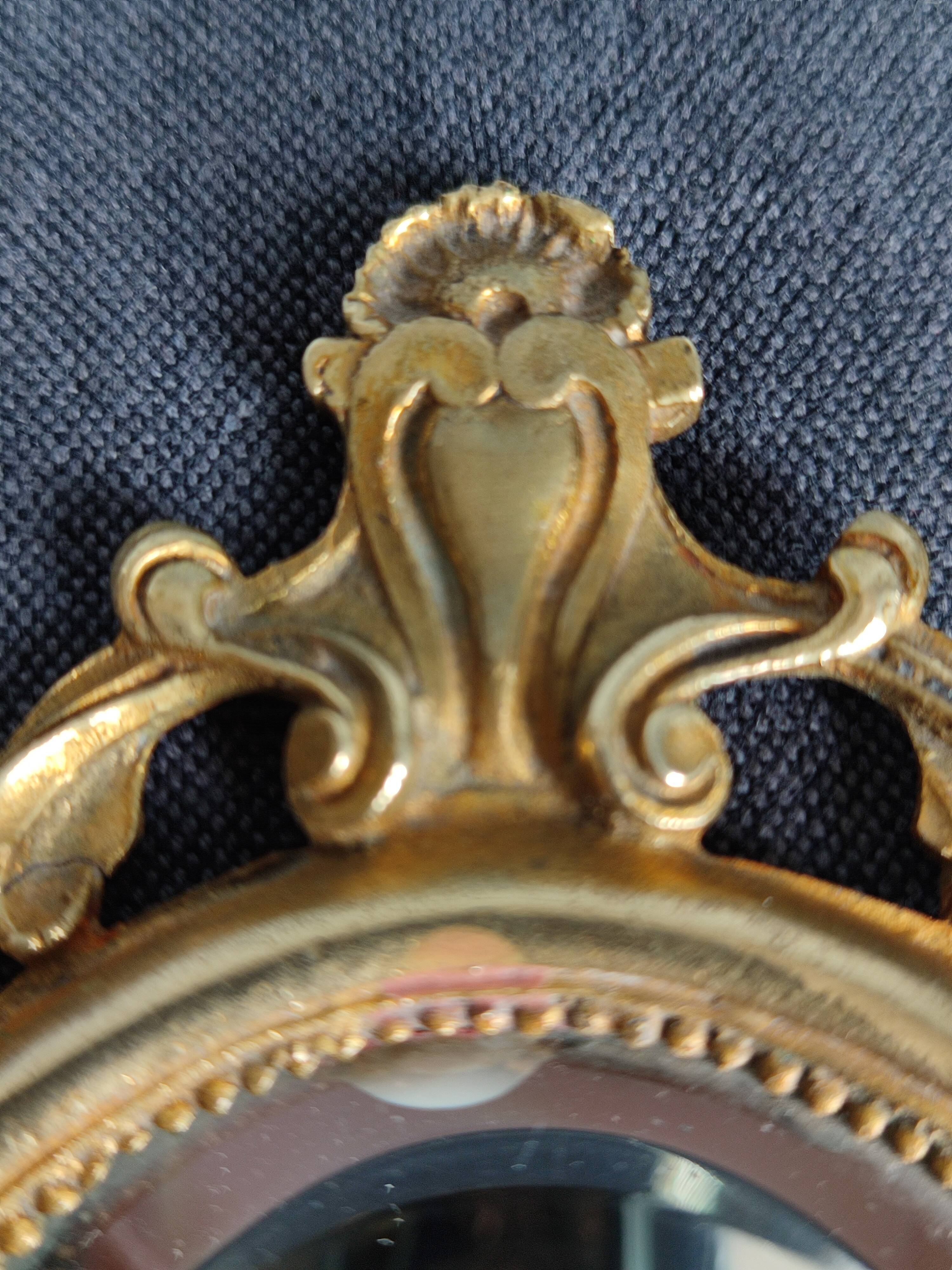 Antique hand-facing mirror in bronze and beveled glass