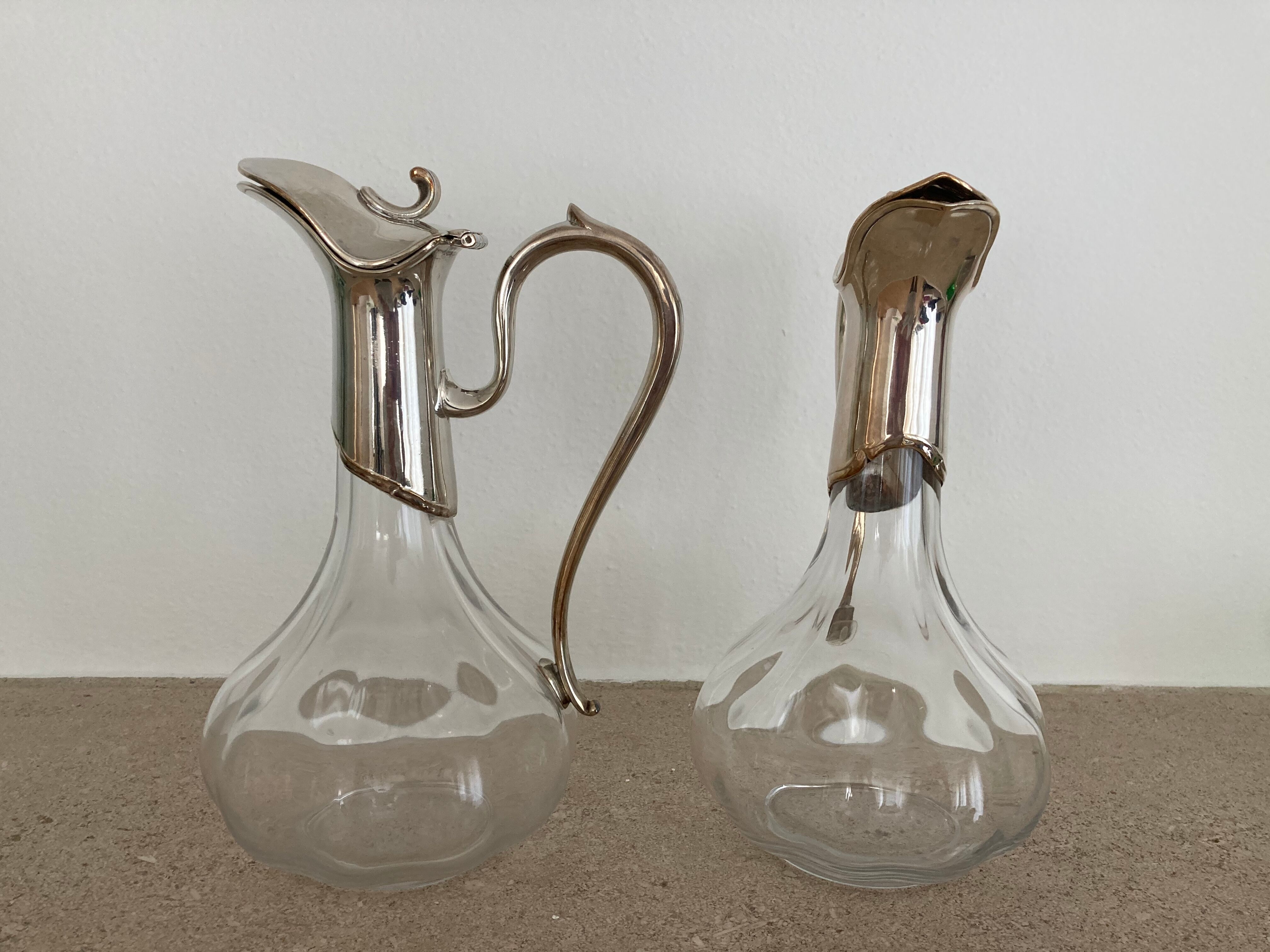 Glass decanters and silver metal spouts
