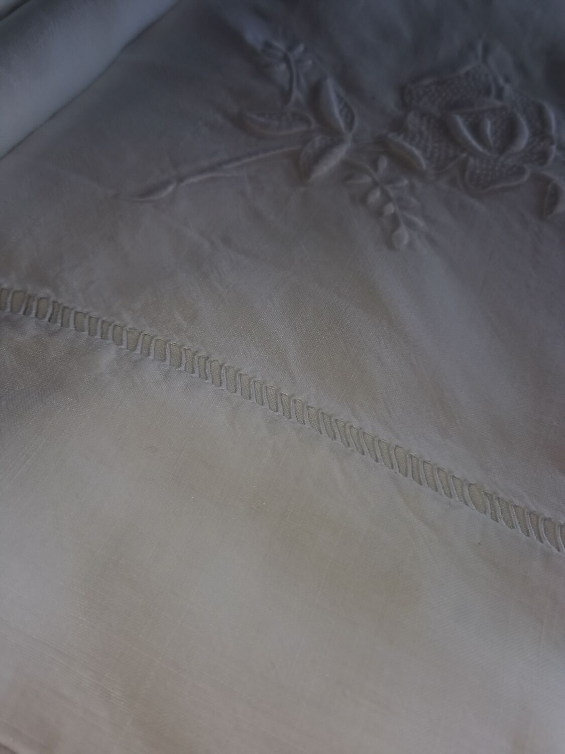 Antique embroidered linen sheet with a monogram.