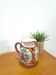Porseleinen vintage roze kan met bloemen