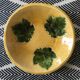 Plate signed with green leaf decoration.