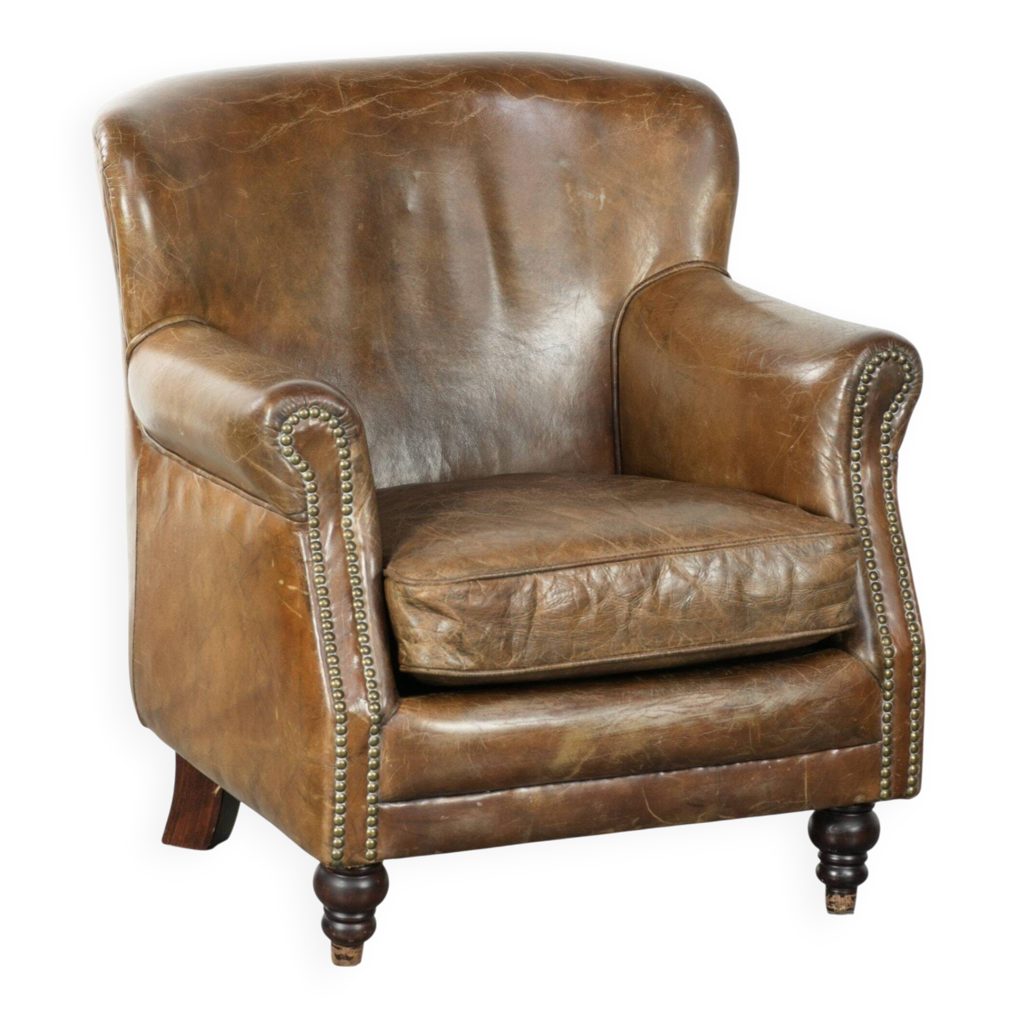 Robust cowhide armchair in a beautifully subtle size with a wonderful patina.