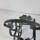 Vintage black wrought iron bottle holder decorated with vine leaves