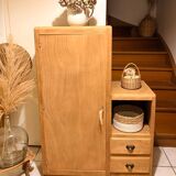 Asymmetrical cabinet made of raw wood