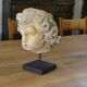 Reconstituted stone sculpture in antique style from the 20th century.