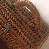 Bagged suitcase in braided wicker and wood