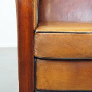 Sheep leather and wooden Art Deco design armchair with ball feet