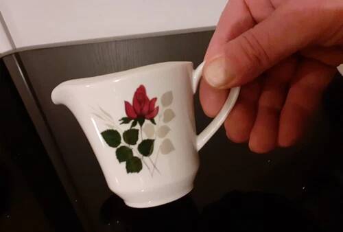 White porcelain coffee service of 3 pieces with a rose design.