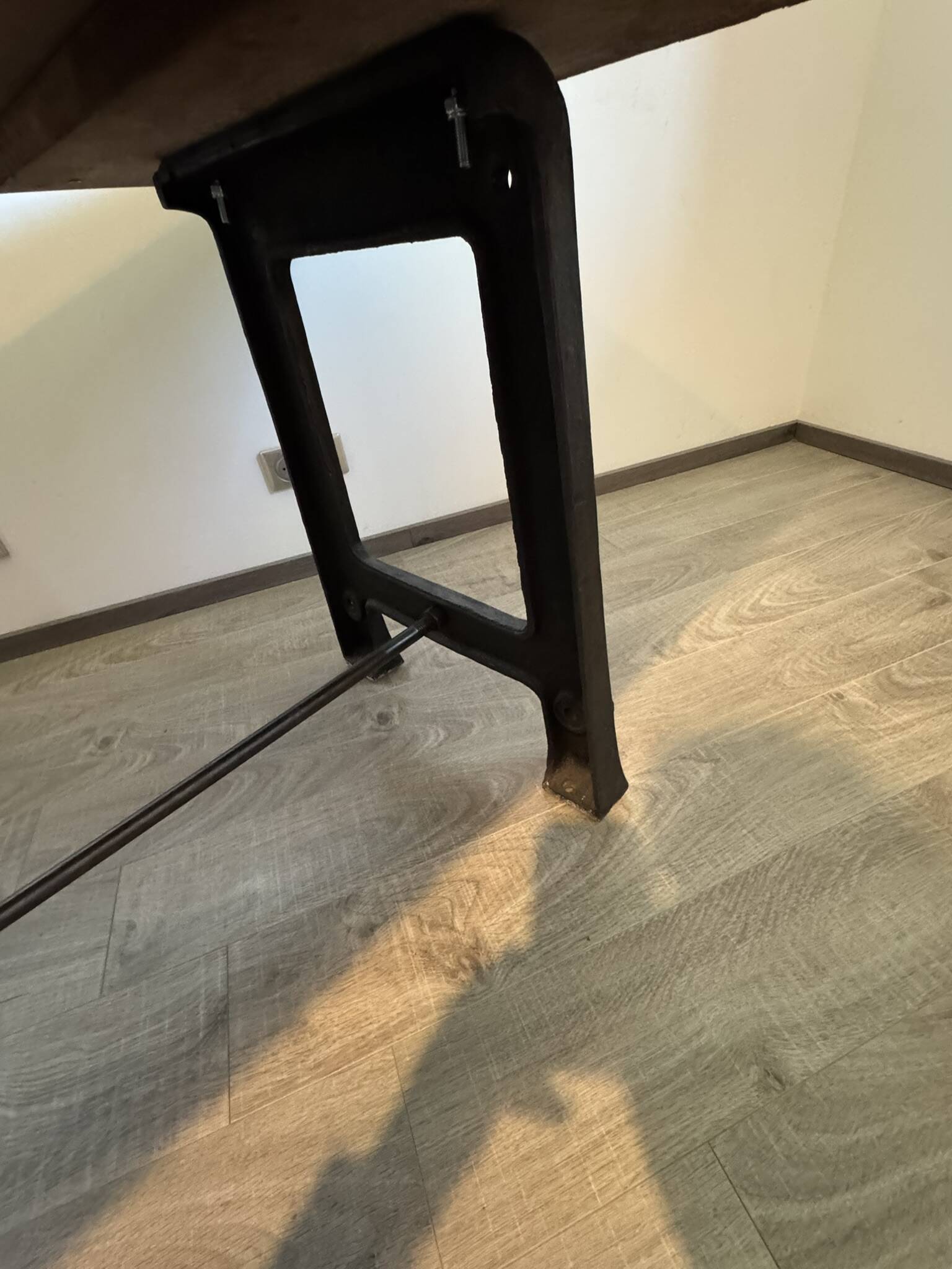 Industrial style table with a mahogany top.