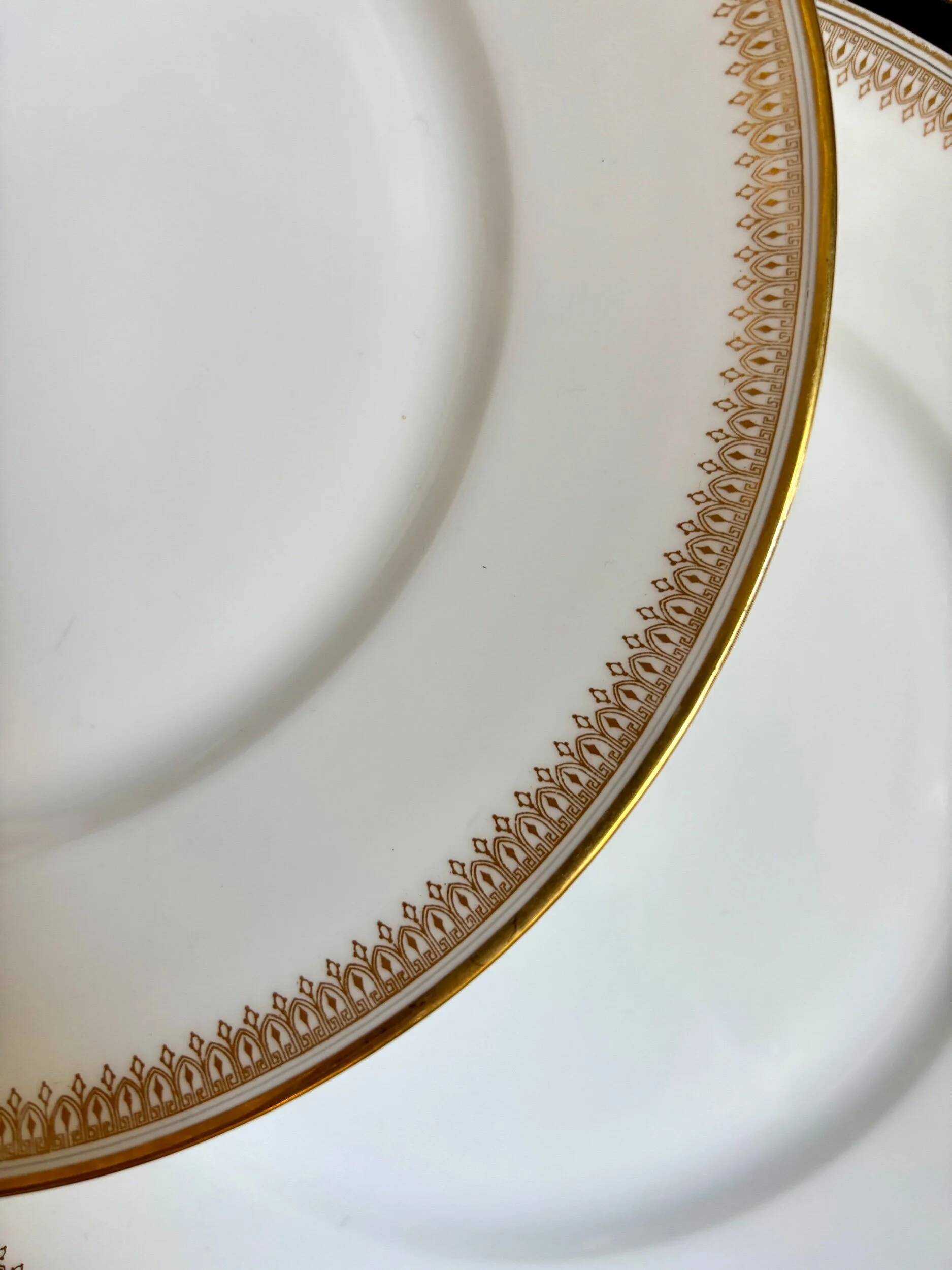 6 flat plates in gold porcelain monogrammed "F"