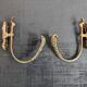 Pair of golden metal tiebacks