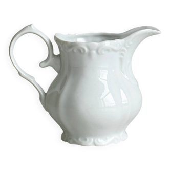 Old white porcelain milk jug, cream jug with relief.