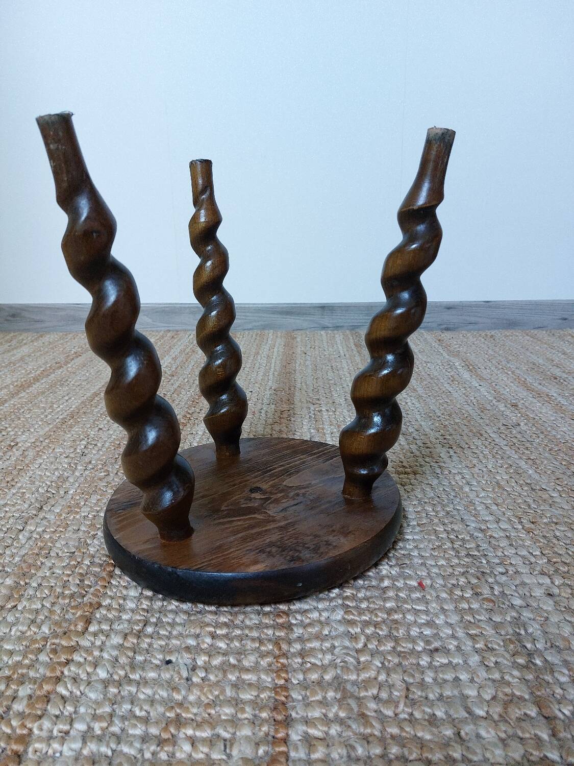 Wooden tripod stool with twisted legs