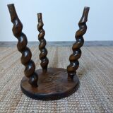Wooden tripod stool with twisted legs