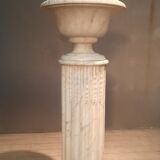 Column topped with a plaster basin.