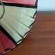 Pleated red and pale yellow plastic conical lampshade from the 1960s.