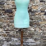 Old mannequin on wooden and fabric stand
