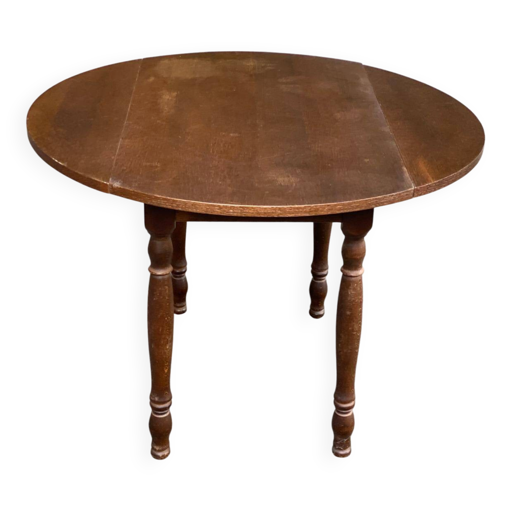 Round kitchen or dining table with extendable leaves in dark wood.