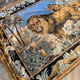 Antique wall tapestry in velvet depicting a scene with a lion and lioness.
