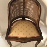 Old wooden armchair and cannage