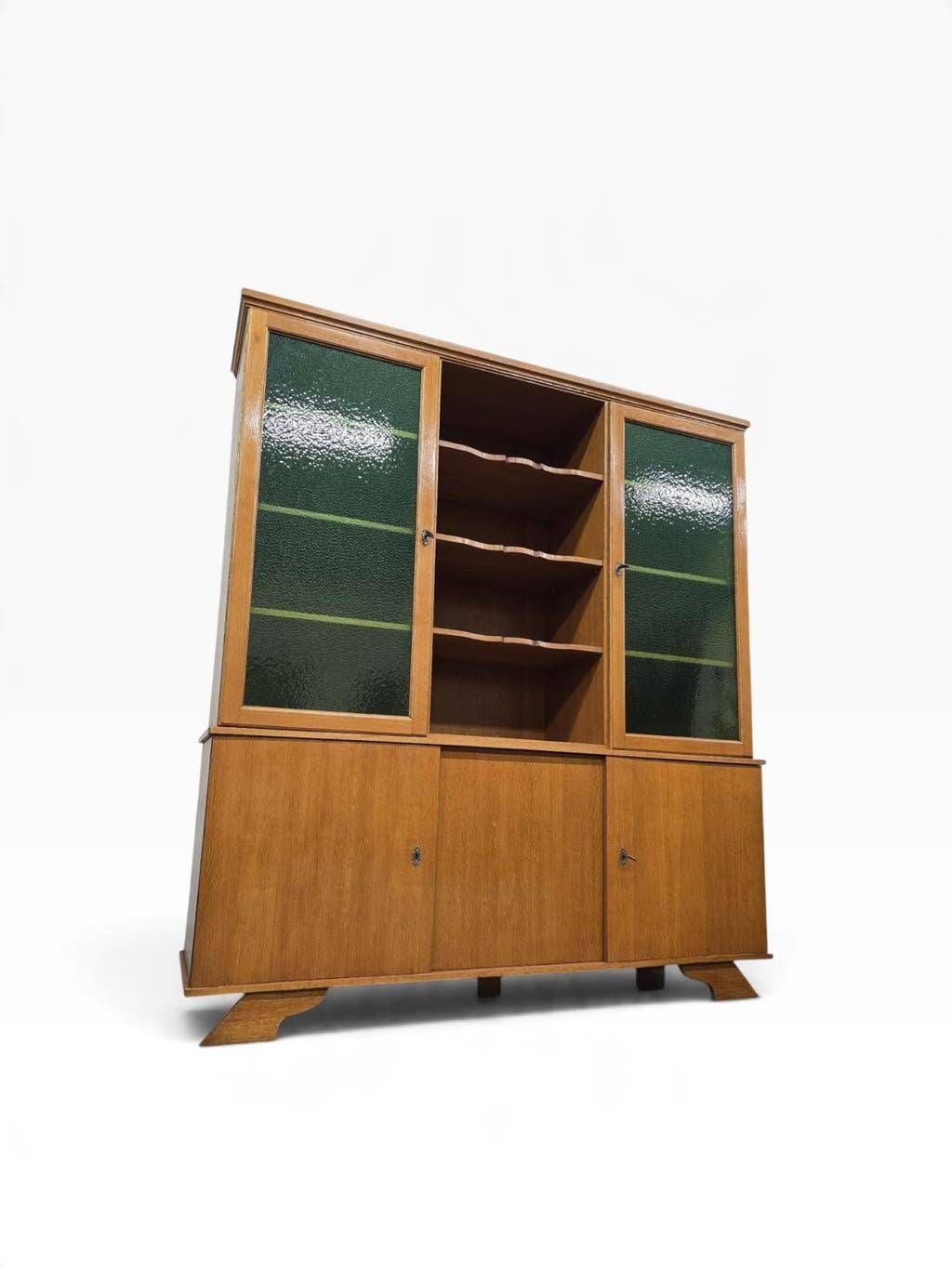Vintage wooden display cabinet with green glass.