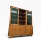 Vintage wooden display cabinet with green glass.