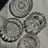 Circular glass ashtray with stylized petal patterns