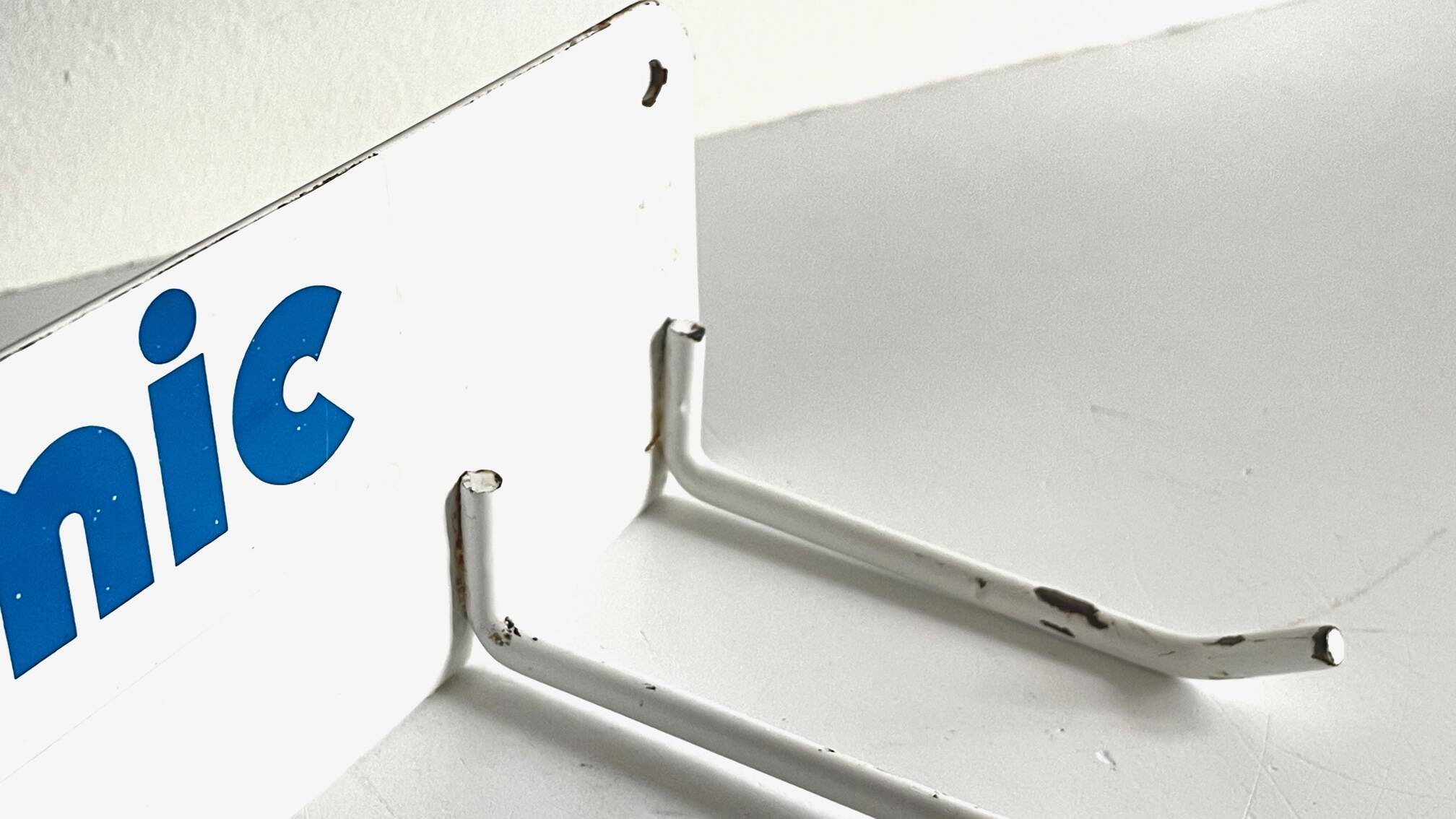 Vintage white metal wall trade coat rack