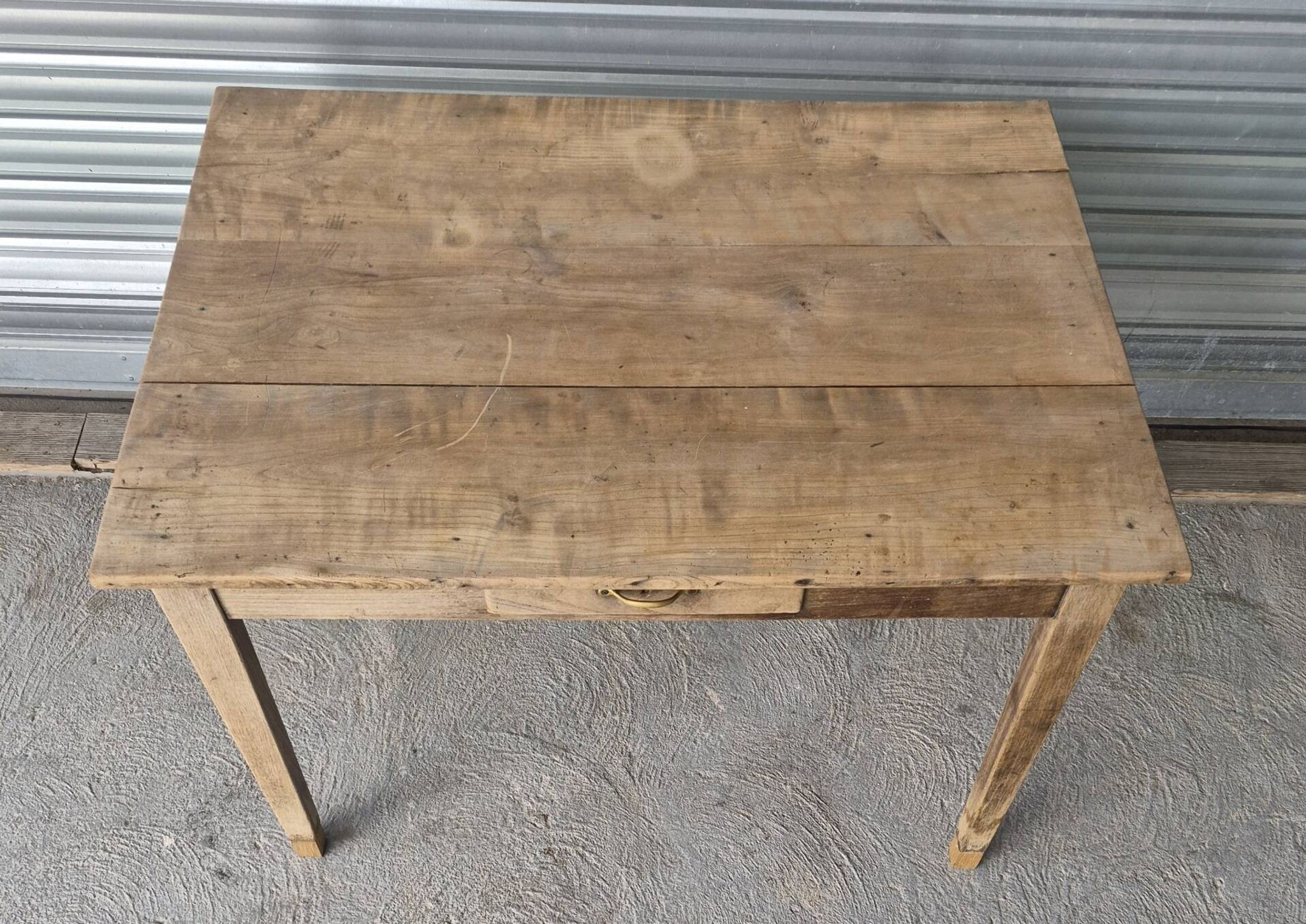 Old farmhouse table with its 2 extensions and raised legs.