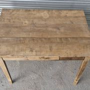 Old farmhouse table with its 2 extensions and raised legs.