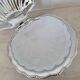 Scallop shell butter dish in stainless steel with its white glass saucer.