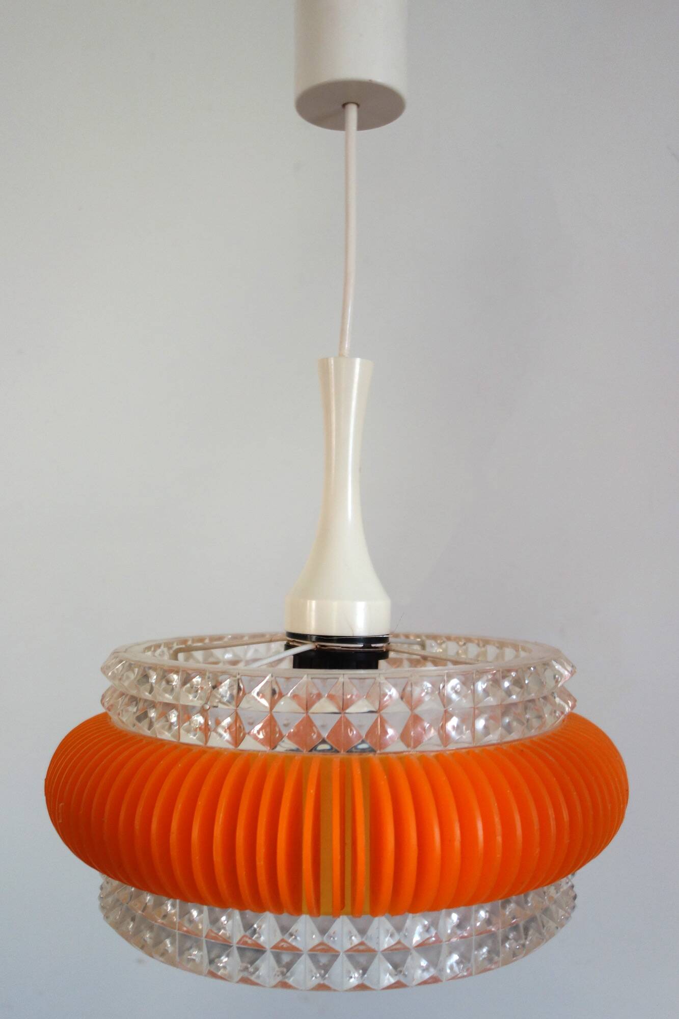 Transparent plastic space age lustre with orange band from the 70s.