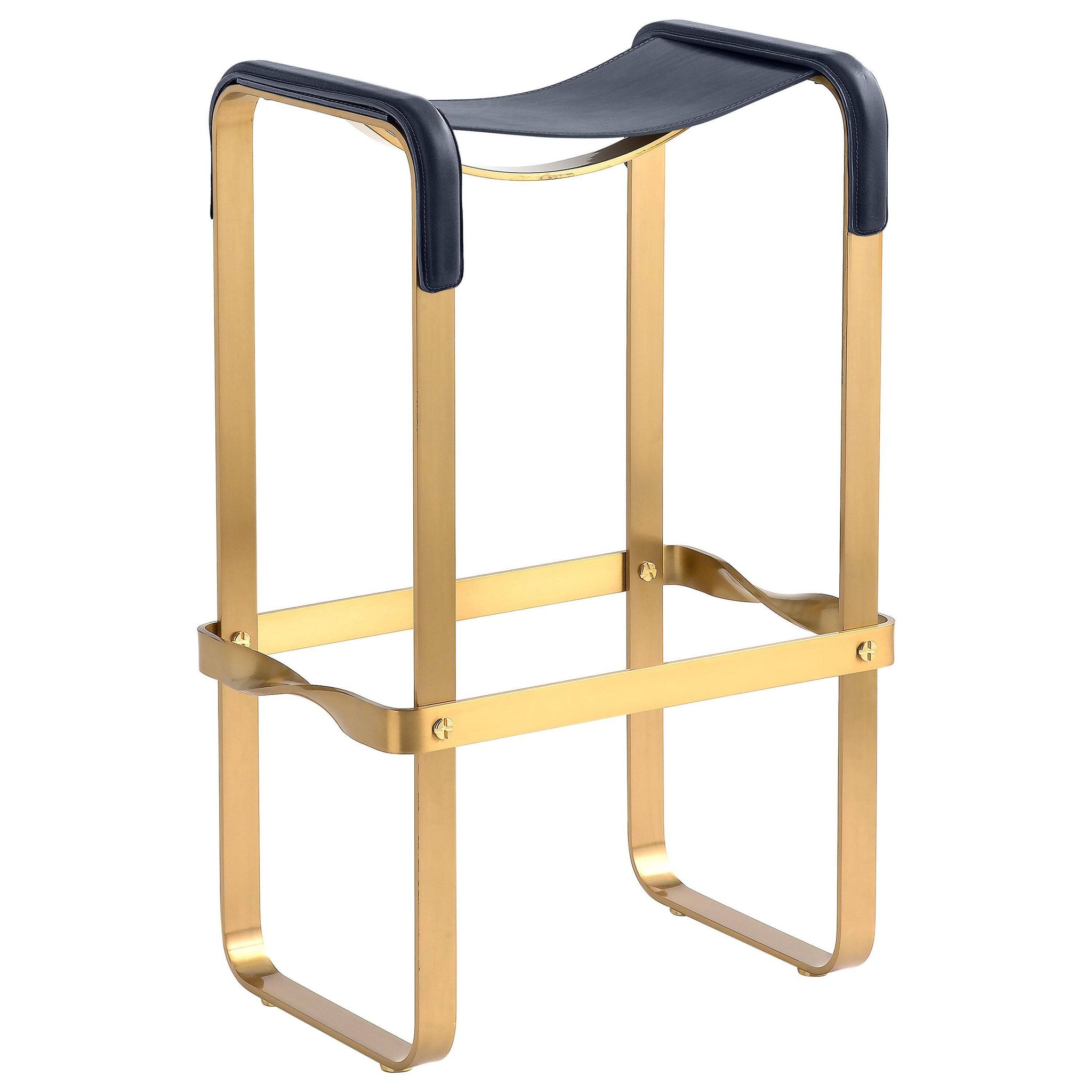 Contemporary kitchen bar stool in aged brass metal and navy blue leather.