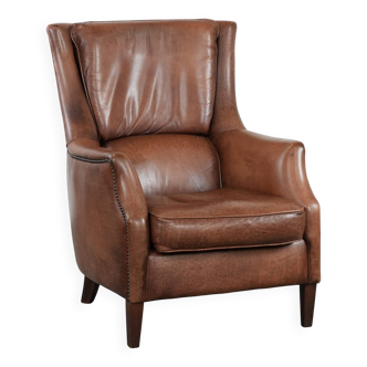 Cognac brown cow leather armchair with decorative nail finish