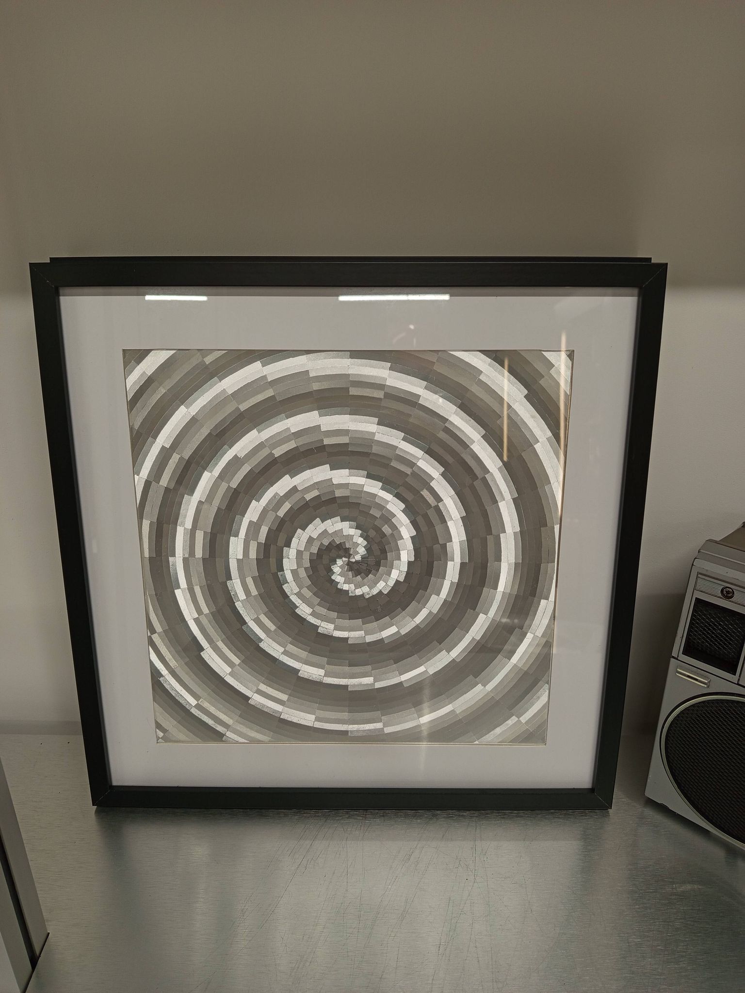 a Kinetic Op Art Aluchromy under glass frame.
