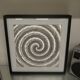 a Kinetic Op Art Aluchromy under glass frame.