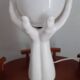 70s lamp two hands embrace an opaline globe