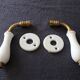 Set of two porcelain door handles with two rosettes